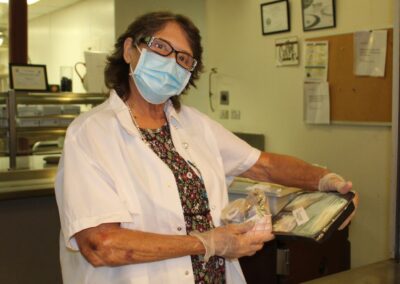 Joan Mahoney distributes Grab and Go meals at the Cambridge Citywide Senior Center